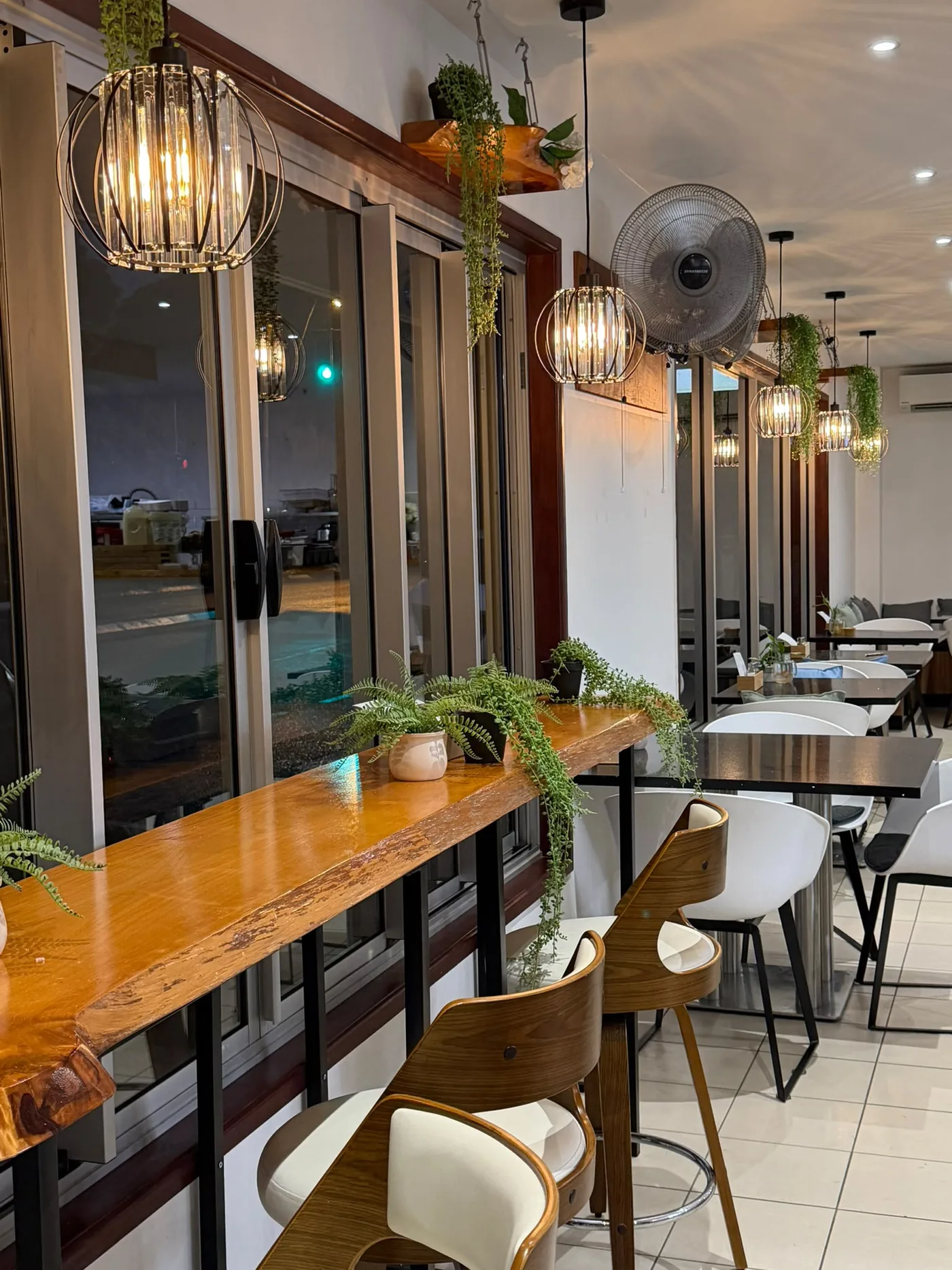 Row of installed pendant lights and fans along a finished commercial cafe fit-out - Cairns City Electrics, Cairns